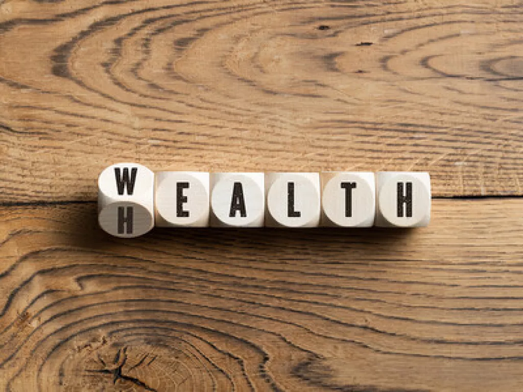 Game pieces that spell out a hybrid of "wealth" and "health"