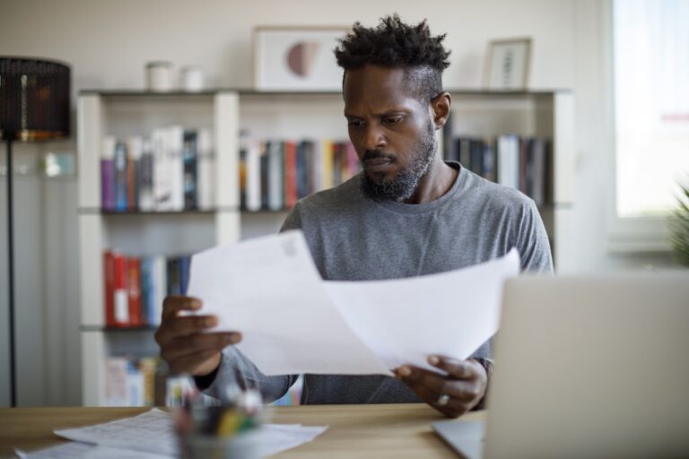 Man comparing loan options at table