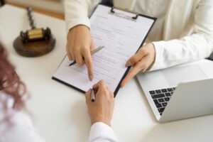 Financial advisor showing client paper with bankruptcy details