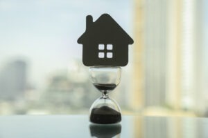 A house-shaped cutout on an hourglass