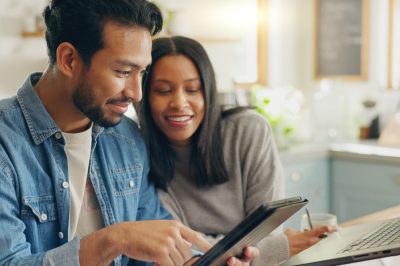 Couple looking at debt on tablet. Authorized Users.