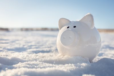 Piggy bank in the snow background, frozen assets.