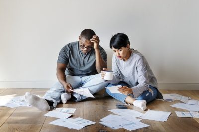 Couple managing a pile of debt papers