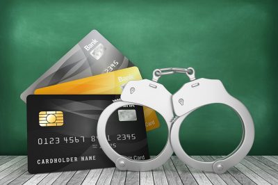 Credit Cards with Handcuffs on Chalkboard