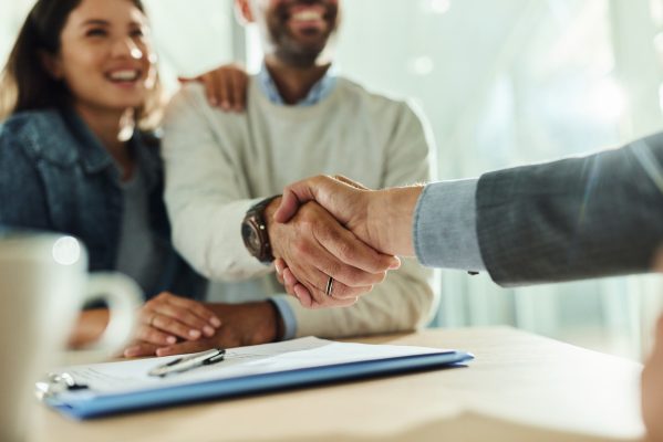 Image of debt collection attorney shaking hands with clients