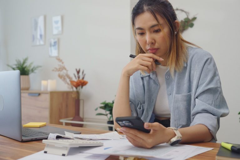 Woman checking bank account to check for possible wage garnishment