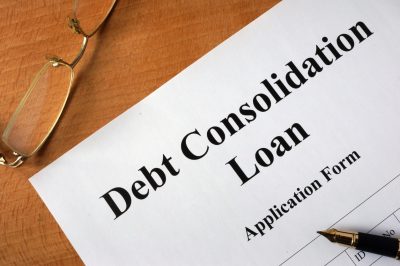 Debt consolidation loan form on a wooden table.