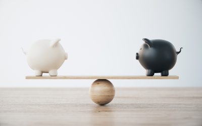 White and Black Piggy Banks On Wooden Seesaw - Comparing financial options