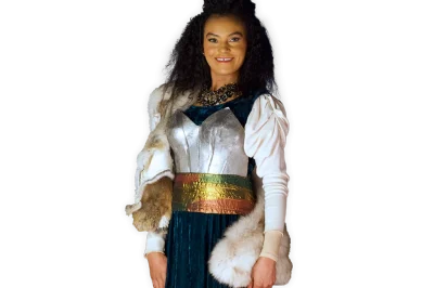 Viking Frida smiling and wearing a breastplate over her dress