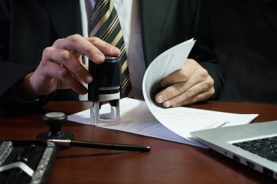 Lawyer stamping legal debt document with dimissal