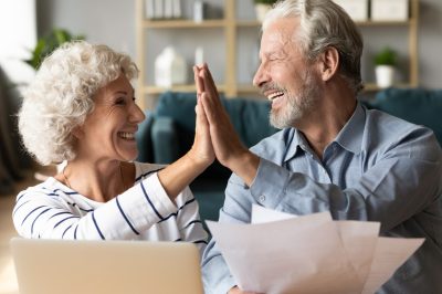 Excited older couple giving high five