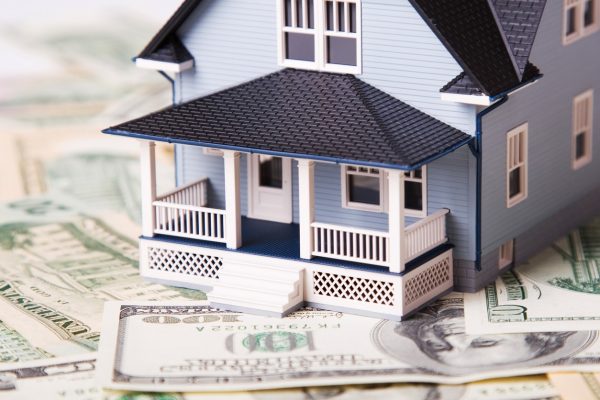 House on different dollar bills. Real estate concept.