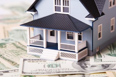 House on different dollar bills. Real estate concept.