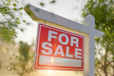 For Sale Real Estate Sign In Front of Property.