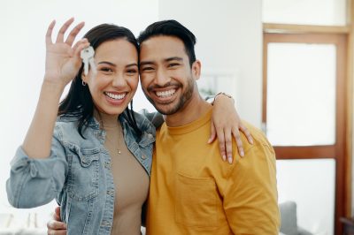 Couple with keys to their first home after debt settlement