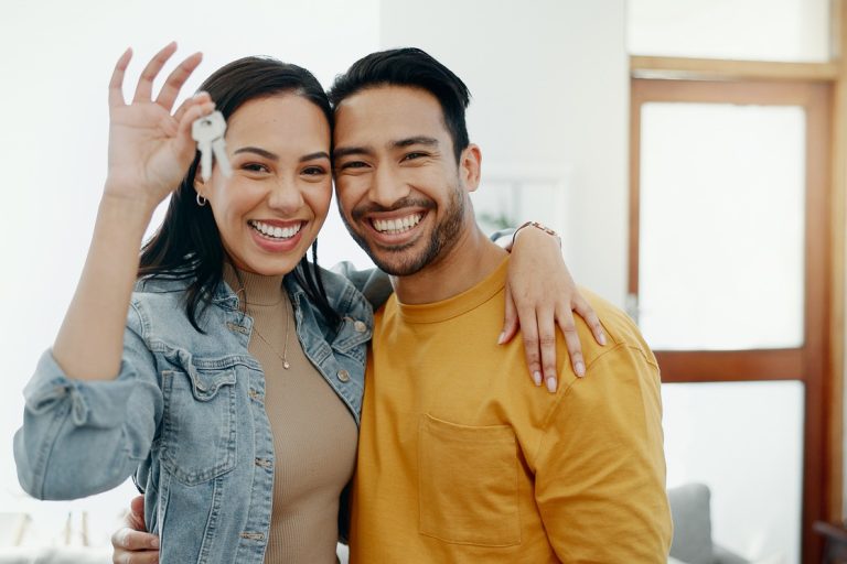 Couple with keys to their first home after debt settlement