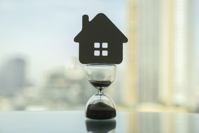 A house-shaped cutout on an hourglass