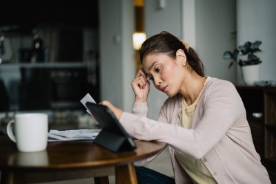 Woman at table looking at finances, considering bankruptcy