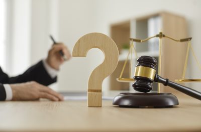 Close up of a question mark and gavel on the table in the courtroom or lawyer's office