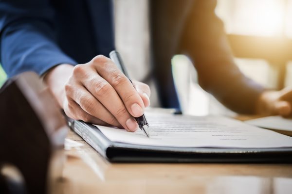 Man signing legal paperwork