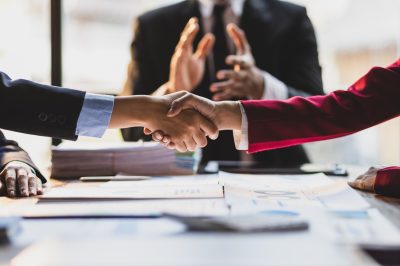 Handshake in front of lawyer after successful negotiation