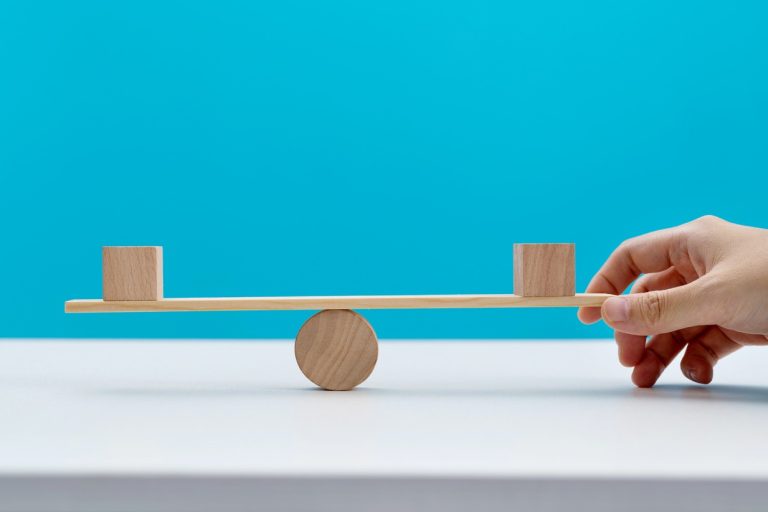 Blank cubes on wooden seesaw