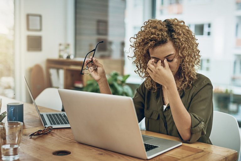 Young woman at home with headache from mold exposure