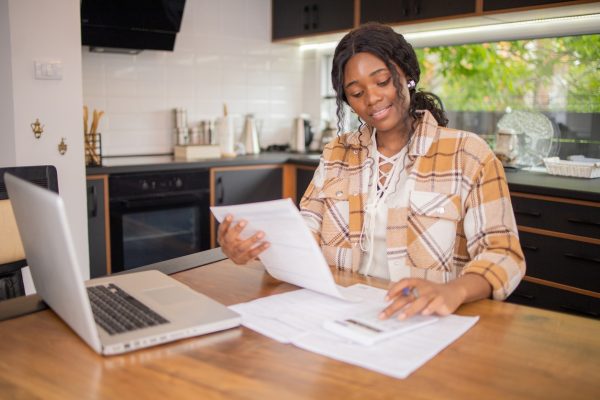 Young woman at computer applying for loan online