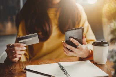 Woman looking at credit score wondering what will happen if she pays off debt