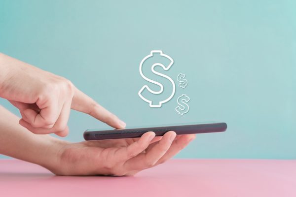 Woman on phone with Cash symbol floating above phone screen