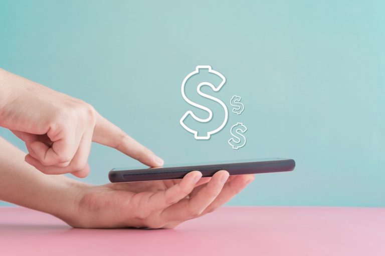 Woman on phone with Cash symbol floating above phone screen