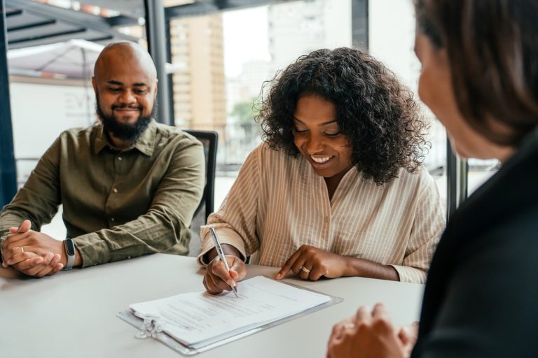 Woman signing loan agreement