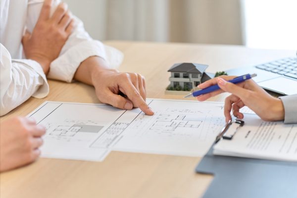 A man discussing the floor plan of a house
