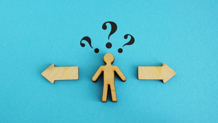 Wooden figure with 2 options. Concept of choosing between debt settlement and court