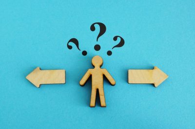 Wooden figure with 2 options. Concept of choosing between debt settlement and court