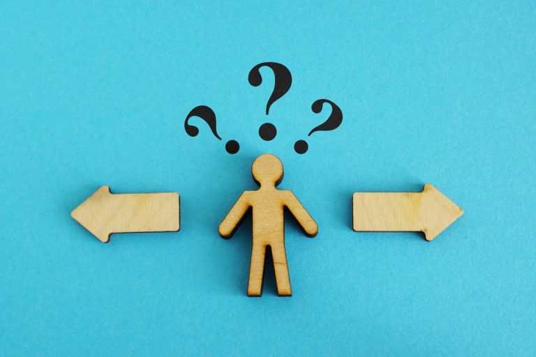 Wooden figure with 2 options. Concept of choosing between debt settlement and court