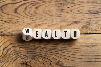 Game pieces that spell out a hybrid of "wealth" and "health"
