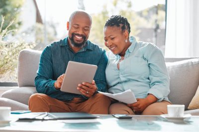 Couple on couch looking at loan prequalification letter
