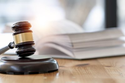 Wooden brown judge gavel on the table, copy space, banner background.