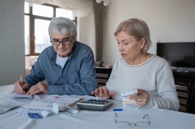 Senior Couple Calculating Budget Together