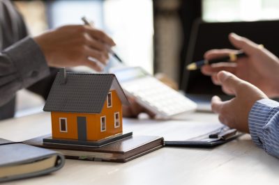 Real estate agent discuss about the terms of the home purchase agreement and asked the customer to sign the documents to make the contract legally, Home sales, lease, mortgage and home insurance.