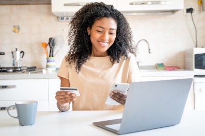 Woman paying off credit card debt and checking credit score
