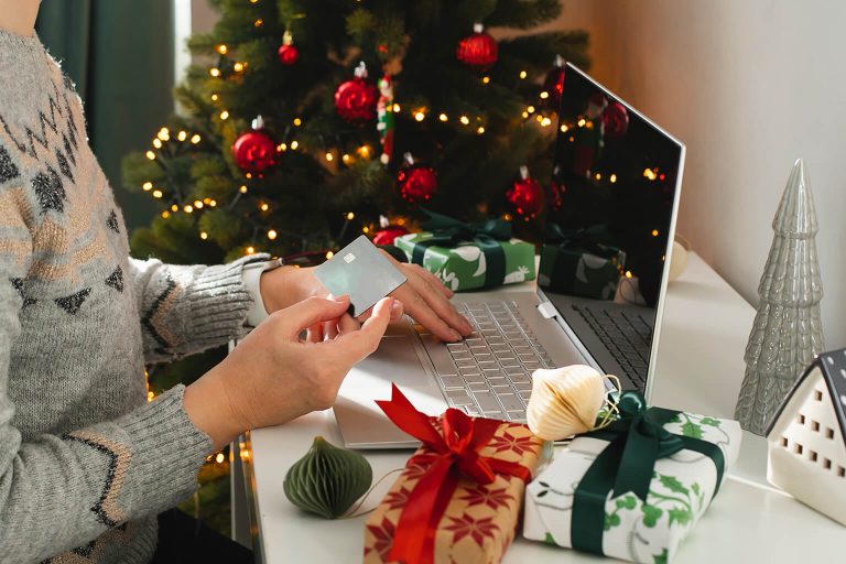 Woman using credit card to make holiday purchases