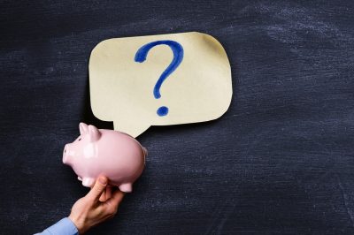 Zombie vs phantom debt. Piggy bank with question mark on paper above.