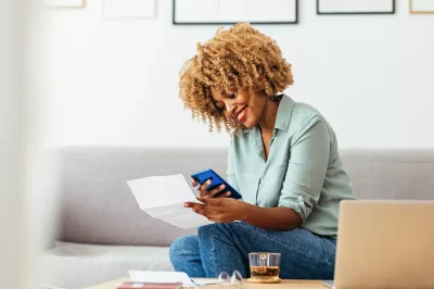 Woman happy with phone and paper