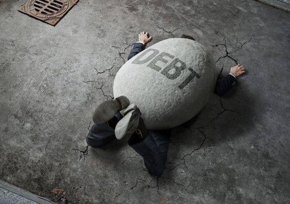 man weighed down by debt