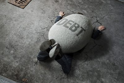 man weighed down by debt