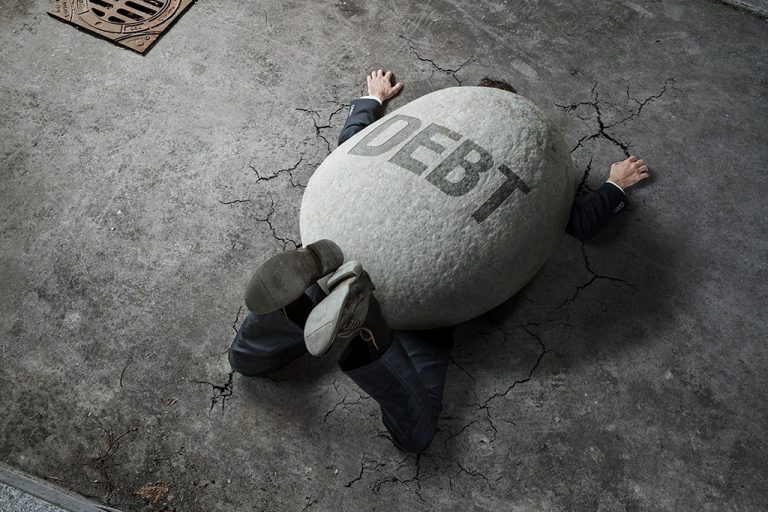 man weighed down by debt